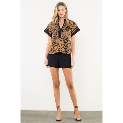Women's short sleeve cheetah print V-neck knit top with 92% polyester and 8% spandex, relaxed fit, modeled in size S.