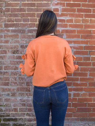 Bow Embellished Crew Neck Sweater-Bow Detail,Bow Embellished,Burnt Orange,clothing,Crew Neck,Drop Shoulder,Knit Sweater,Knit Top,Ribbed Crew Neck,Ribbed Hem,Ribbed Neckline,Sweater,Sweaters,Top,Tops,Women,women's-[option4]-[option5]-[option6]-Bella Bliss Boutique in Texas