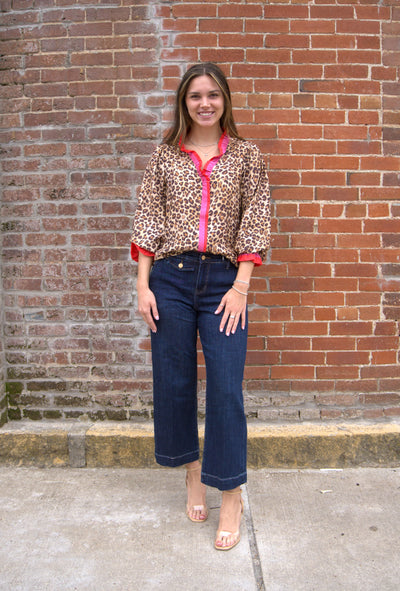 Women’s leopard print top with wavy stripe trim on long sleeves and relaxed fit
