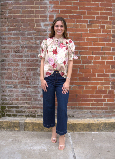 Women’s floral print top with smocked bodice, V-neckline, short puff sleeves, and ruffle trim details