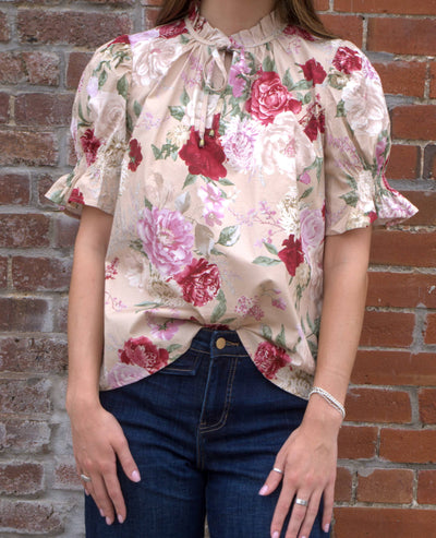 Women’s floral print top with smocked bodice, V-neckline, short puff sleeves, and ruffle trim details