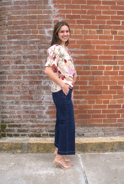 Women’s floral print top with smocked bodice, V-neckline, short puff sleeves, and ruffle trim details