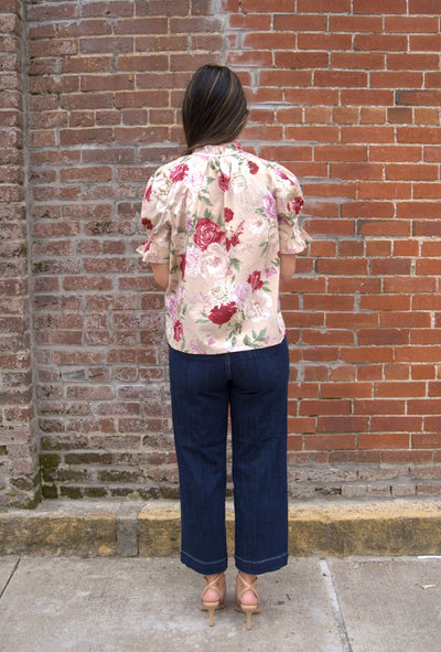 Women’s floral print top with smocked bodice, V-neckline, short puff sleeves, and ruffle trim details