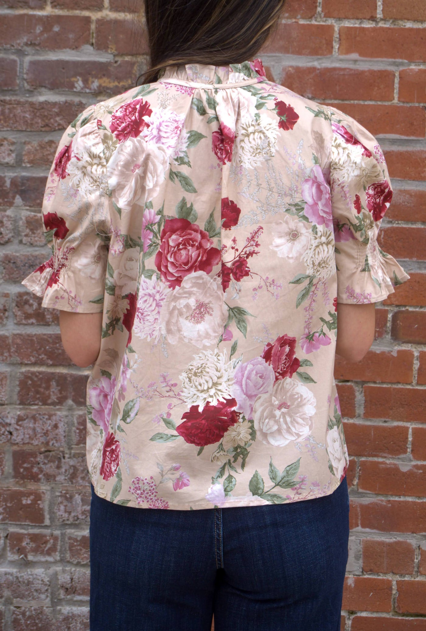 Women’s floral print top with smocked bodice, V-neckline, short puff sleeves, and ruffle trim details