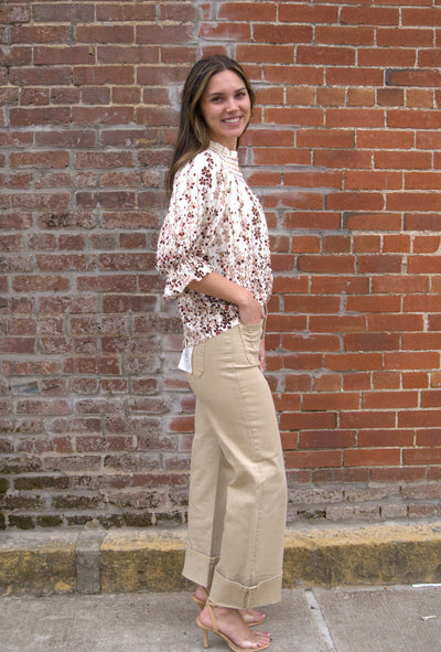 Women’s vibrant floral top with smocked yoke, zig-zag stitching, puff sleeves, and button-front detail