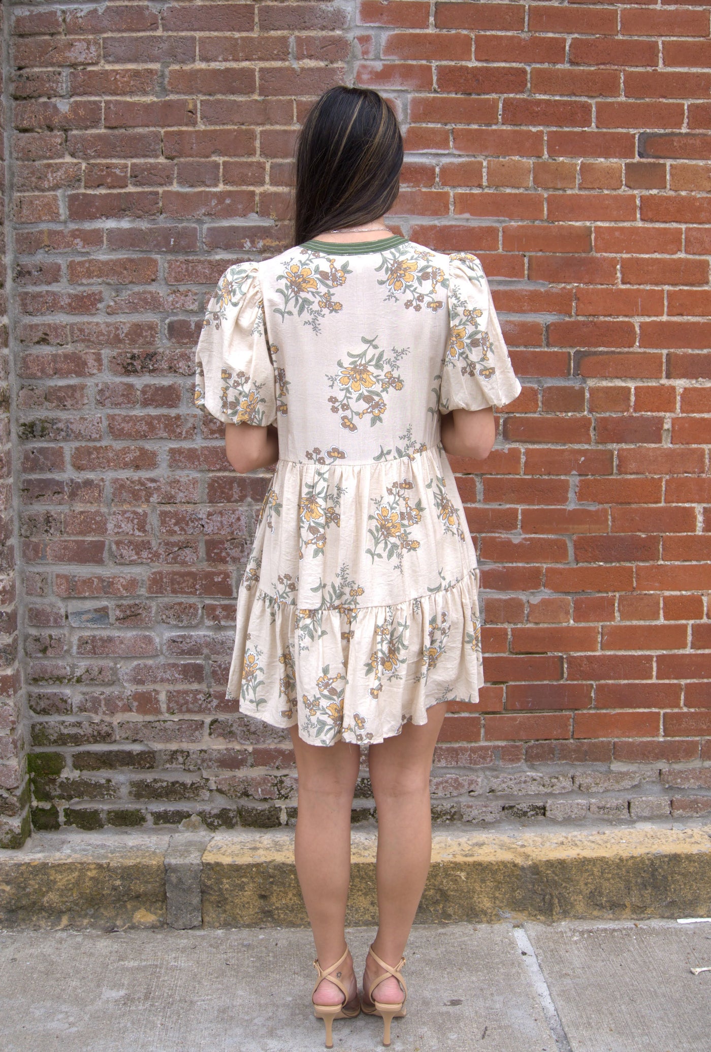 Women’s floral mini dress with short puff sleeves, V-neckline, and side pockets.