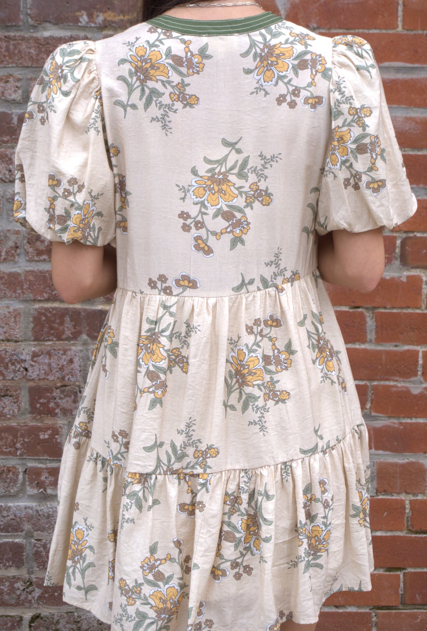 Women’s floral mini dress with short puff sleeves, V-neckline, and side pockets.