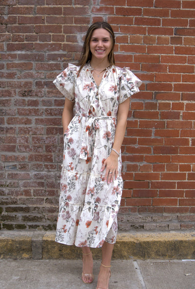 Women’s floral midi dress with flutter sleeves, ruffled V-neckline with tie, adjustable waist, and side pockets.