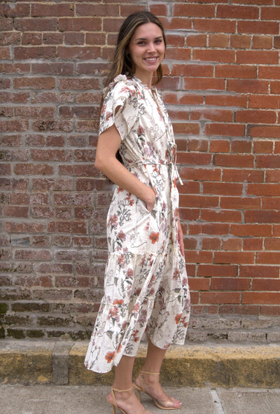 Women’s floral midi dress with flutter sleeves, ruffled V-neckline with tie, adjustable waist, and side pockets.