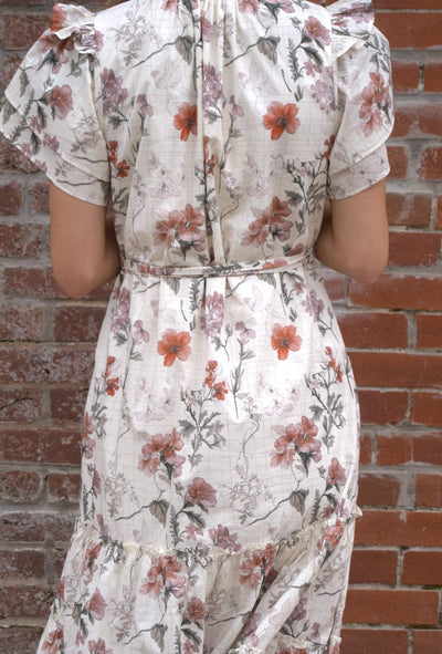 Women’s floral midi dress with flutter sleeves, ruffled V-neckline with tie, adjustable waist, and side pockets.