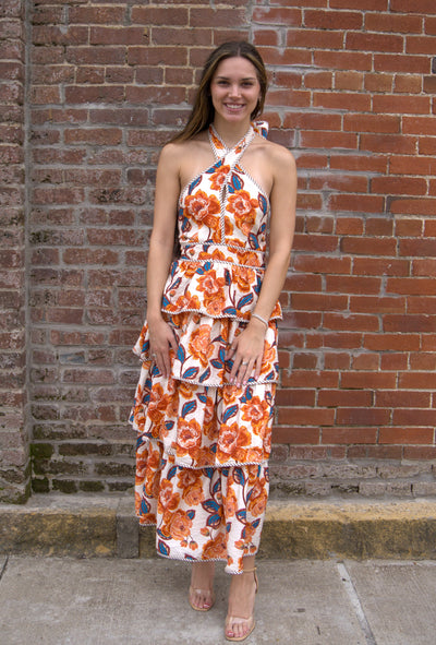 Women’s floral halter midi dress with bow tie neckline, contrast binding, smocked back, and tiered skirt